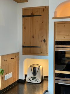 a kitchen area with an oven, toaster and microwave