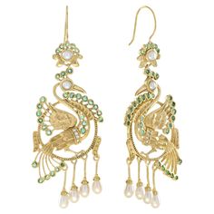 Let these beautiful birds bring you joy in more way than one. The peacock represents happiness. Dangle our Peacock Earrings from your lobes as exotic statement pieces. These detailed and layered earrings are in 14k yellow gold. The earrings feature emerald, diamond and peal that will shimmy along with you. Information Metal: 14K Yellow Gold Width: 25 mm. Length: 69 mm. Weight: 13.80 g. (approx. in total) Backing: French Wire Gemstones I Type: Emerald Shape: Round Size: 1.3 - 1.8 mm. Number: 62 Weight: 1.56 Carat (approx. in total) Gemstones II Type: Diamond Shape: Round Size: 1.1 mm. Number: 8 Weight: 0.05 Carat (approx. in total) Gemstones III Type: Pearl Shape: Round & Drop Size: 3.5 – 5 mm. Number: 12 Weight: 2.96 Carat (approx. in total) These earrings will be made to your order in 1-2 Luxury Traditional Bridal Earrings With Peacock Design, Layered Earrings, Peacock Earrings, Number 12, Pearl Dangle Earrings, Earring Box, The Peacock, French Wire, Pearl Earrings Dangle