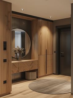 a room with wooden cabinets and a round mirror on the wall, along with a rug