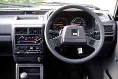 the interior of a car with dashboard and dash lights, steering wheel controls and instrument panel