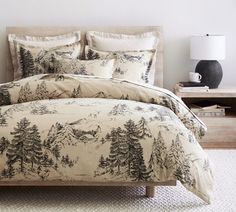 the comforter is made up with pine trees on it