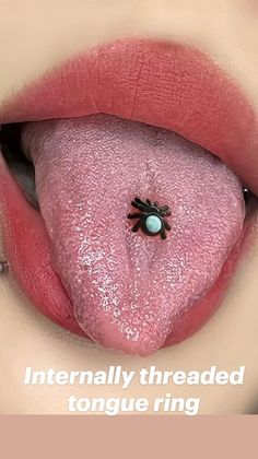 a woman's lips with a fake spider on the top of her lip and an eyeball in the middle