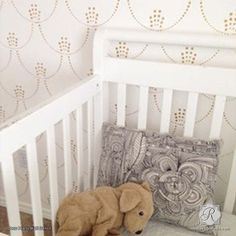 a stuffed animal laying on top of a pillow in a crib next to a pillow