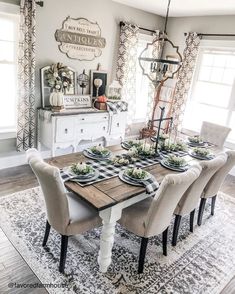 the dining room table is set with place settings for six people, and there are several chairs around it