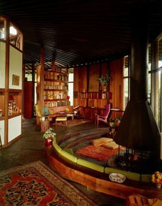 a living room filled with lots of furniture and bookshelves