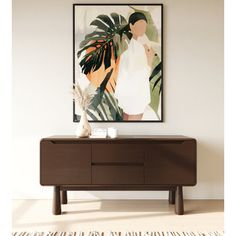 a painting hanging on the wall above a dresser with a plant in front of it