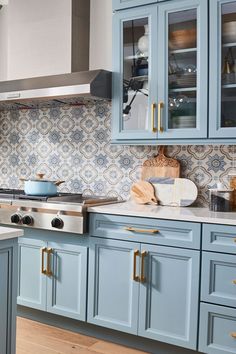 a kitchen with blue cabinets and white counter tops