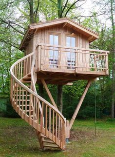 a tree house with a spiral staircase going up to the top floor and second story