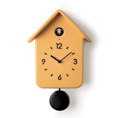 a yellow clock with black hands and numbers on the face is hanging from a wall