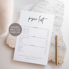 a price list sitting on top of a table next to a pen and paper towel