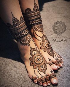 the feet are decorated with henna tattoos