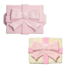 two pieces of pink fondant with bows on them