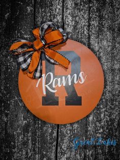 an orange and black round sign with the number 11 on it that says, rams