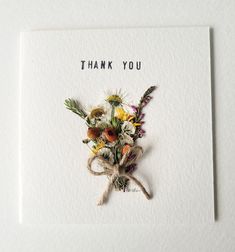 a thank you card with dried flowers on it