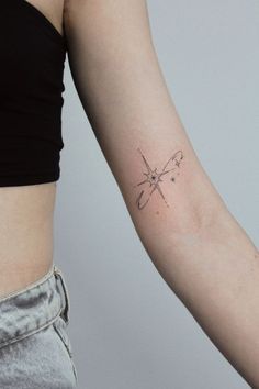 a woman's arm with a small tattoo on the left side of her arm