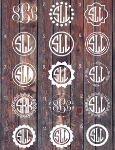 six monogrammed decals on wood with the initials and numbers in different styles