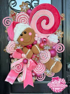 a wreath made to look like a gingerbread man with pink and white candy canes