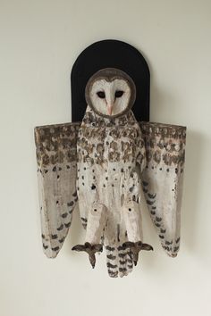 an owl figurine is hanging on the wall