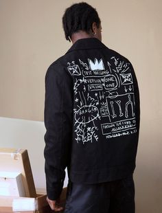 This mechanic's jacket features a bold print of Basquiat's artwork Beat Bop on the back of the jacket. On the front, you will find Basquiat's own signature embroidered at the front pocket and the RPO logo above the cuff on the in white thread on the left side. 100% cotton twill in black Body and sleeves are lined with 100% cotton 2-way zipper at front Hidden zip welt pocket at wearer's left interior, and an open pocket at wearer's right interior Basquiat's signature embroidery at front left pock Mechanics Jacket, Jean Michel Basquiat, Jean Michel, Bold Prints, Embroidery Logo, Welt Pocket, Front Pocket, Cotton Twill, Rome