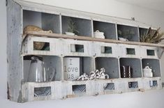 an old wooden shelf filled with containers and cups