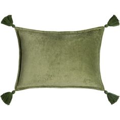 a green velvet pillow with tassels