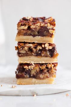 three bars stacked on top of each other with walnuts and pecans in the middle