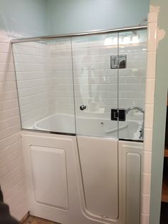 a bathroom with a walk in shower next to a bath tub