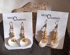 These are hand crafted fish hook and cockle seashell earrings of my own design.  I use various beads and metal embellishments to enhance the seashell's design. Any of the pearl beads are pearl in color not in substance. If you have any questions about any item, please ask. Thank you. 8 ) Handmade Pearl Shell-shaped Earrings, Handmade Pearl Earrings In Shell Shape, Handmade Shell-shaped Pearl Earrings For Gifts, Handmade Shell Pearl Earrings For Gift, Handmade Shell-shaped Pearl Earrings Gift, Metal Embellishments, Seashell Earrings, Scallop Shell, Scallop Shells