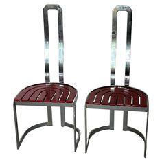 two metal and wood chairs sitting side by side