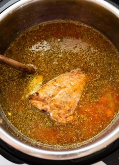 the chicken is being cooked in an instant pot with broth, spices and seasonings