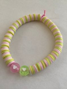 This bracelet is made to be Spring themed. 🌷 All bracelets are made to be 7 inches. If you would like a specific size, please let me know.  An easy way to measure your wrist size is to wrap a string around your wrist, measure, and add 1/2 inch. The bracelet is made with Heishi beads. Adjustable Personalized Plastic Jewelry, Handmade Plastic Bracelets For Birthday, Plastic Bracelets As A Gift, Playful Green Adjustable Bracelets, Adjustable Green Playful Bracelets, Handmade Adjustable Plastic Friendship Bracelets, Playful Green Plastic Bracelets, Adjustable Playful Bracelets, Cute Adjustable Plastic Stretch Bracelet