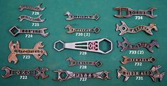 several different types of wrenches are displayed on a green surface with numbers and symbols