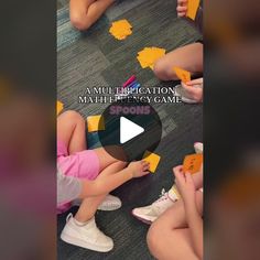 children are sitting on the floor playing with blocks and letters that read, a multi - application math / emergency game