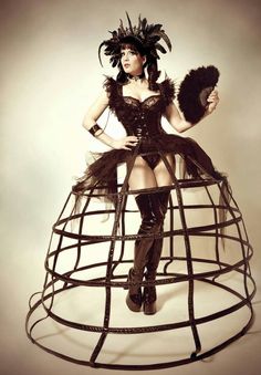 Designed with elastic waistband and ruffles, this petticoat offers a comfortable and adjustable fit. This bewitching skirt is designed to enchant and captivate with its dark and daring style. Its unique cage design adds an edgy and mysterious flair to any outfit, making it ideal for gothic-inspired events. Embrace the darkness, express your individuality, and make a dramatic entrance at your next Halloween soirée or festival with our gothic cage skirt. Victorian Cage Skirt, Plant Dress, Stilt Costume, Cage Skirt, Cage Dress, Skirt Diy, Black Cage, Hoop Skirt, Estilo Punk