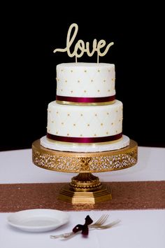 a wedding cake with the word love on top