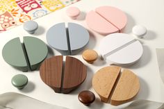 several different shapes and sizes of wooden objects on a white surface with various colored paper