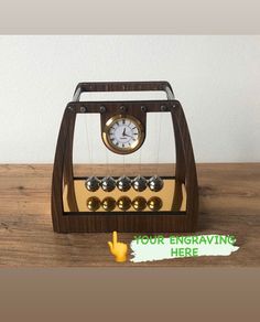 an old fashioned pendulum clock on a wooden table