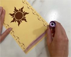 someone is making a card with the sun on it