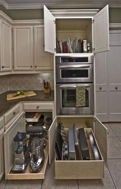 an open drawer in the middle of a kitchen