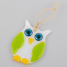 a ceramic owl ornament hanging on a string