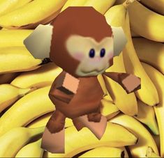 a bunch of bananas with a cartoon monkey on it's chest and some other bananas in the background