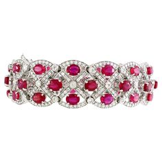 Elegance and opulence come together in this stunning bracelet adorned with 45 oval-shaped rubies, each possessing a rich and fiery allure. With a total weight of 22.47 carats, these rubies are securely held in a delicate yet robust 4-prong setting, allowing their natural beauty to shine through. The rubies are complemented by a symphony of 405 dazzling white diamonds, with a combined carat weight of 3.71 carats. These diamonds are skillfully placed in a combination of shared prong and bezel sett Luxury Ruby Bracelets Elegant Style, Dressy Hats, Ruby Bracelet, Modern Bracelets, White Gold Bracelet, Large Gift, Fine Jewels, Ruby Diamond, Yellow Sapphire