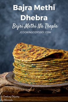 a stack of flatbreads on a plate with the words bajra methi dh