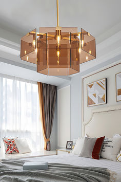 a bedroom with a large bed and a chandelier hanging from the ceiling above it