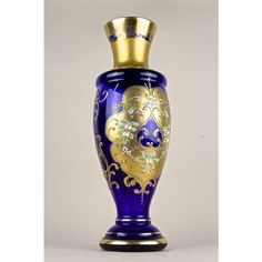 a blue and gold vase sitting on top of a table