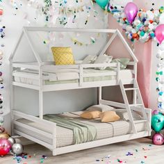 a white bunk bed sitting next to a wall with balloons