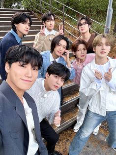 a group of young men standing next to each other in front of stairs and steps