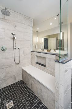 a large bathroom with a walk in shower next to a bathtub and sink area