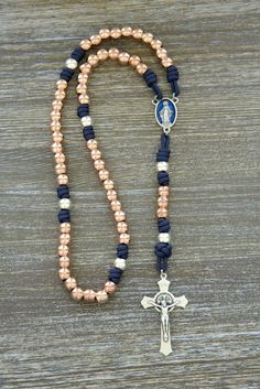 Are you tired of settling for ordinary rosaries that can't keep up with your active, faith-filled lifestyle? Look no further! Sanctus Servo has crafted a divine solution for you – the Splendor of the Stars | Rose Gold and Navy Blue Premium Metal Paracord Rosary.

This stunning Catholic gift is more than just an accessory; it's a spiritual weapon designed to withstand life's battles while helping you draw closer to our Lord and Savior, Jesus Christ. Adjustable Rose Gold Spiritual Rosary, Rosary Ideas, Rosary Design, Rosary Making, Paracord Rosary, Expensive Stones, Holy Rosary, St Benedict, Our Father