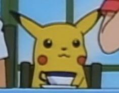 a pikachu is eating from a bowl